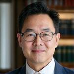 Portrait of Professor Liam Chen, a distinguished male researcher in his 50s with an approachable demeanor.